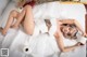 A woman laying on top of a bed covered in toilet paper.