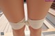 A close up of a doll's legs tied up with a bandage.