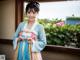 A woman in a blue and pink hanbok posing for a picture.