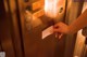 A person is opening an elevator door with a card.